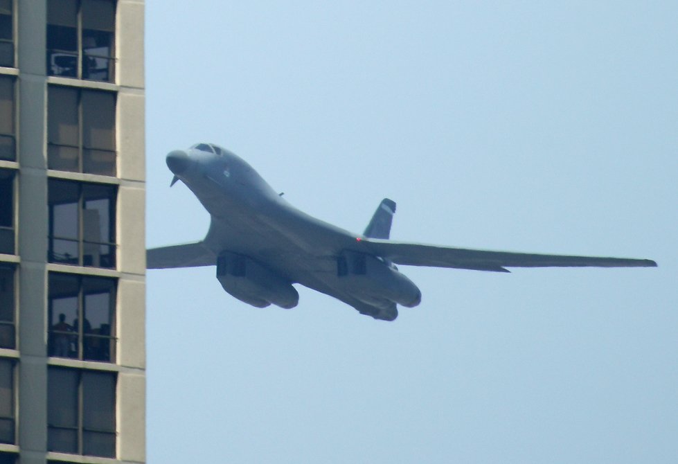 B-1 Lancer bomber approaching apartment building