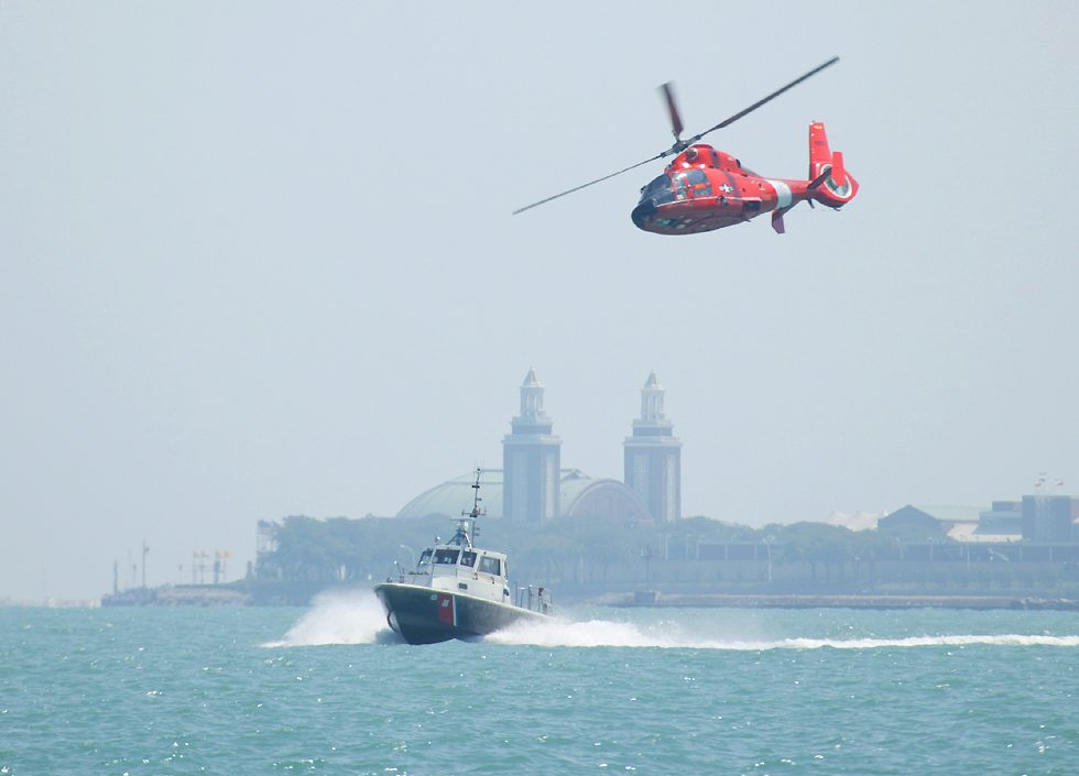 Coast Guard HH65 Dolphin helicopter and Coast Guard boat