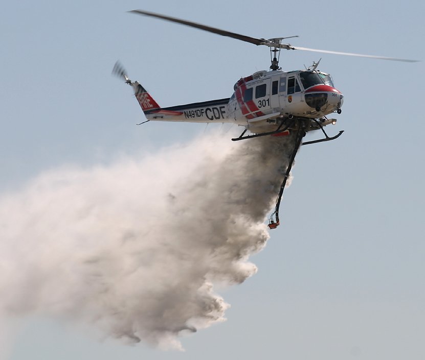 UH-1 Iroquois dropping water during a fire fighting demonstration