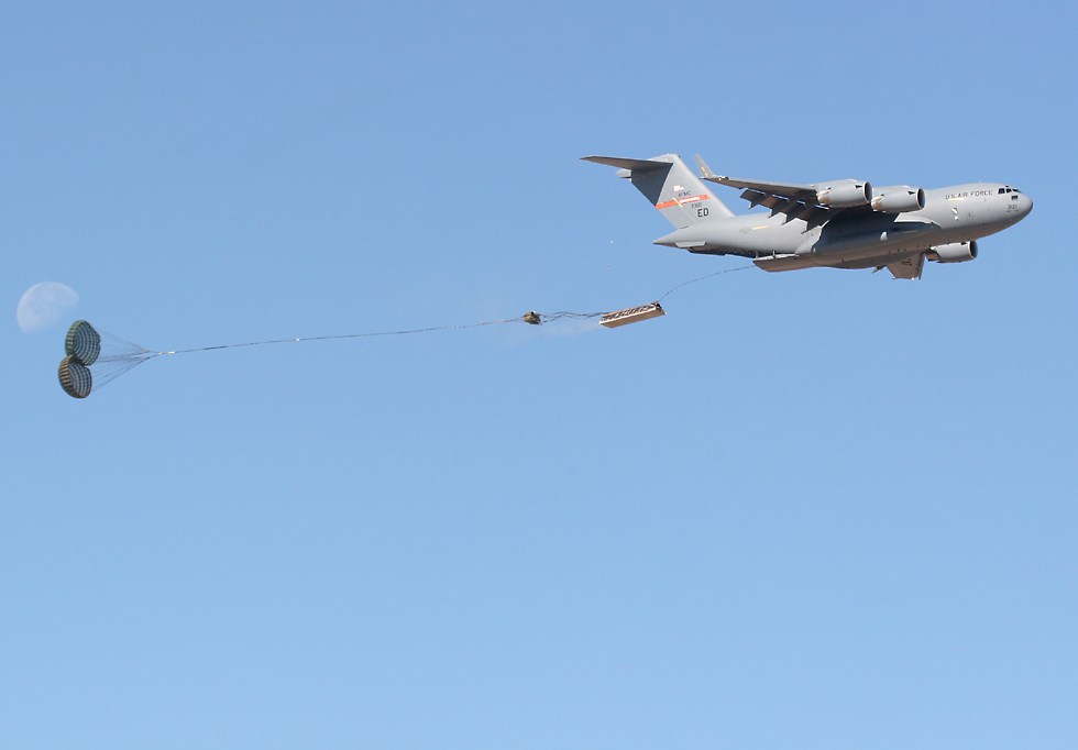 C-17 Globemaster III dropping a pallet by parachute