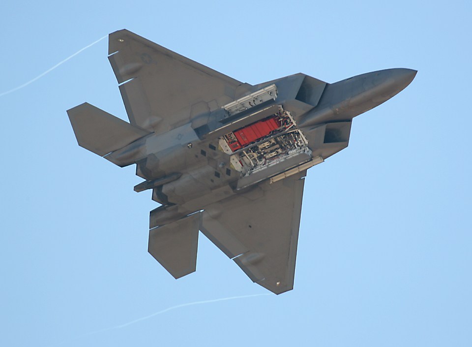 F-22 Raptor doing a pass with its weapons bays open
