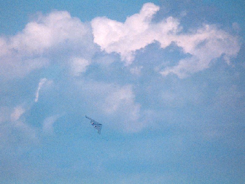 B2 banking around for a second flypast with a background of fluffy cumulus clouds