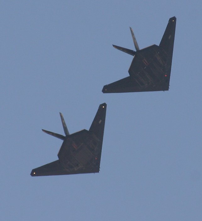 two F-117 Nighthawk 'stealth fighters' banking