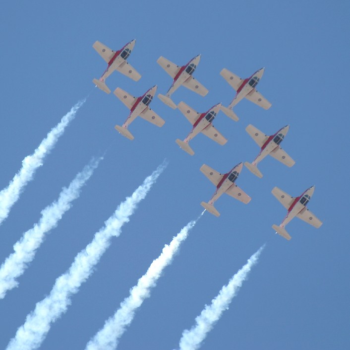 The Canadian Air Force Snowbirds jet display team doing a barrel roll