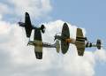 Kittyhawk, Corsair, Spitfire and Mustang flying in formation