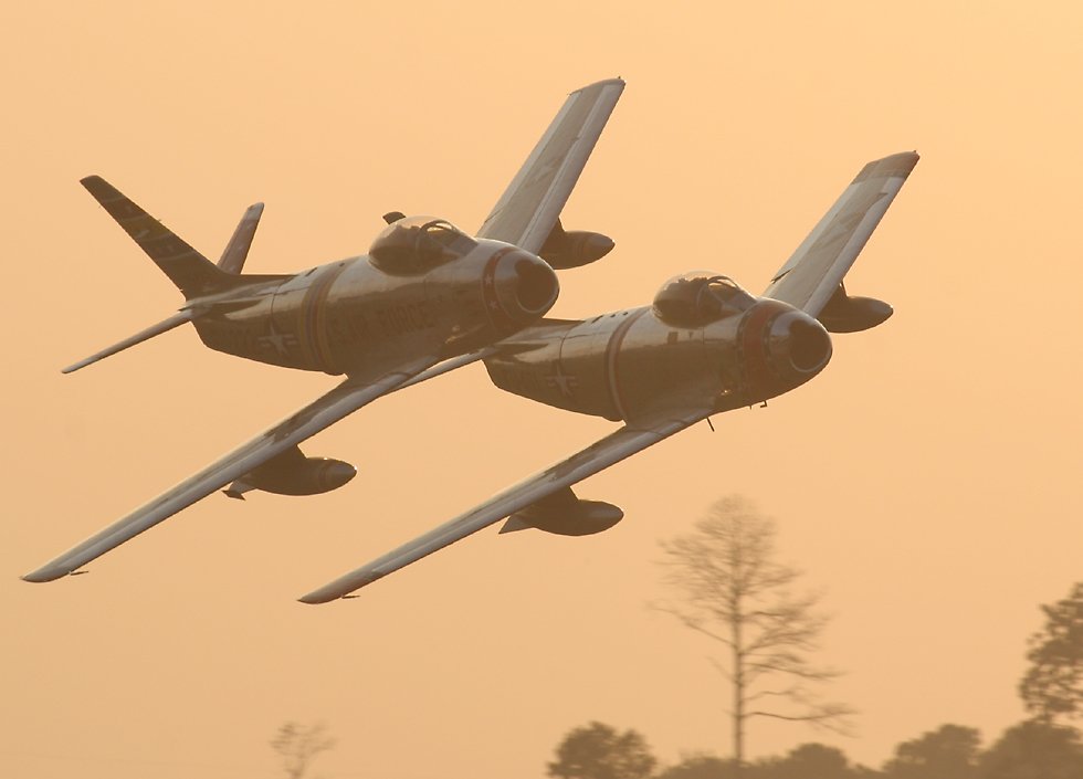 F-86 Sabres in formation at twilight