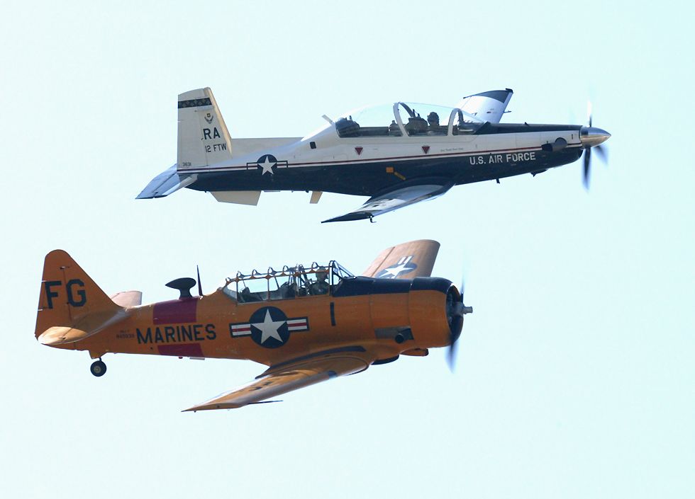modern T-6A Texan II and world war two T-6 Texan training planes in formation