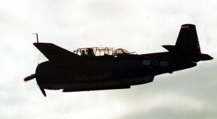 Side view silhouette of Grumman Avenger flying level.