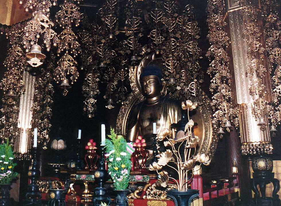 sitting Buddha statue surrounded by gold-plated bells