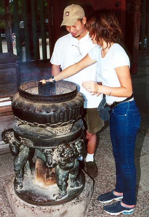 young couple at Todai-ji temple incense brazier