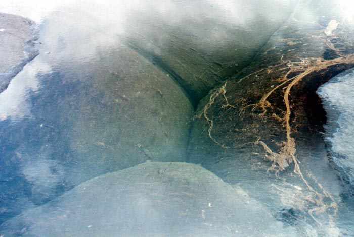 water-filled hole being enclosed by four huge blobs of tar