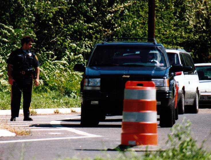 Policeman desperately trying to convince motorists that there's nothing to see here.