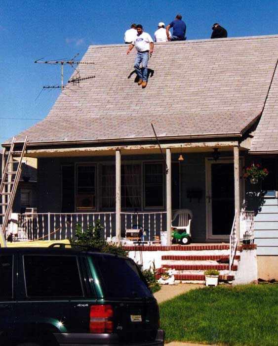 guys watching goings-on from their roof