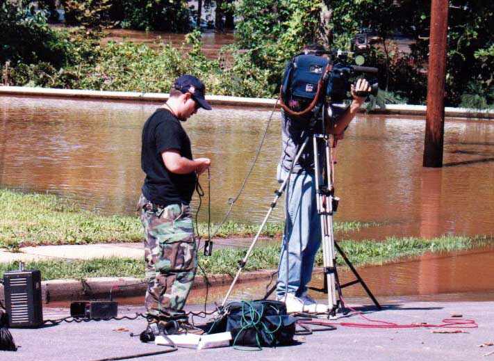 TV crew filming flooding on Canal Rd.
