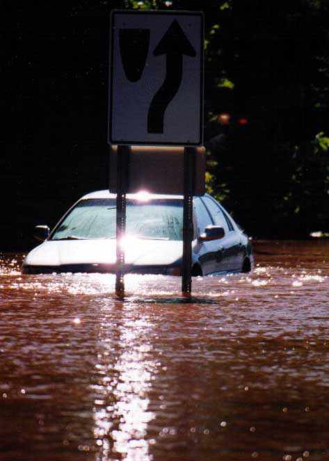 Keep Right sign in front of flooded car.