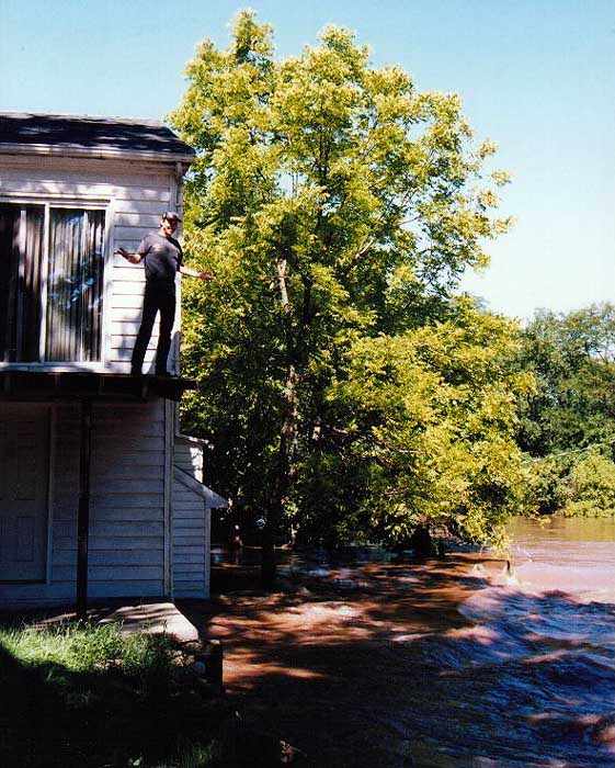 Guy on roof of flooded house whose dog was in the basement.