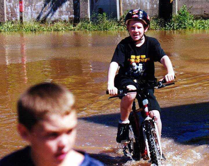 Kids riding bicycles along Canal Road.