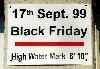 water level sign outside a Main St garage showing the water level for 'Black Friday'