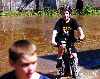 kid riding BMX bike down flooded street