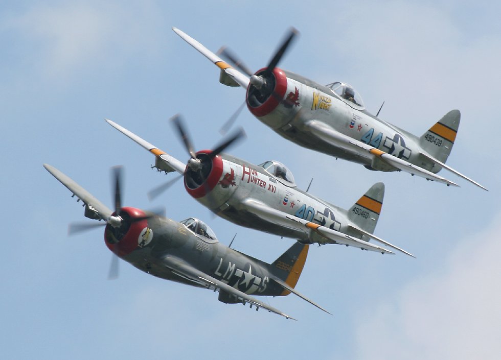 three P-47 Thunderbolts in formation   (click here to open a new window with this photo in computer wallpaper format)