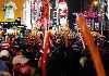crowd decked out with tinsel wigs and balloons