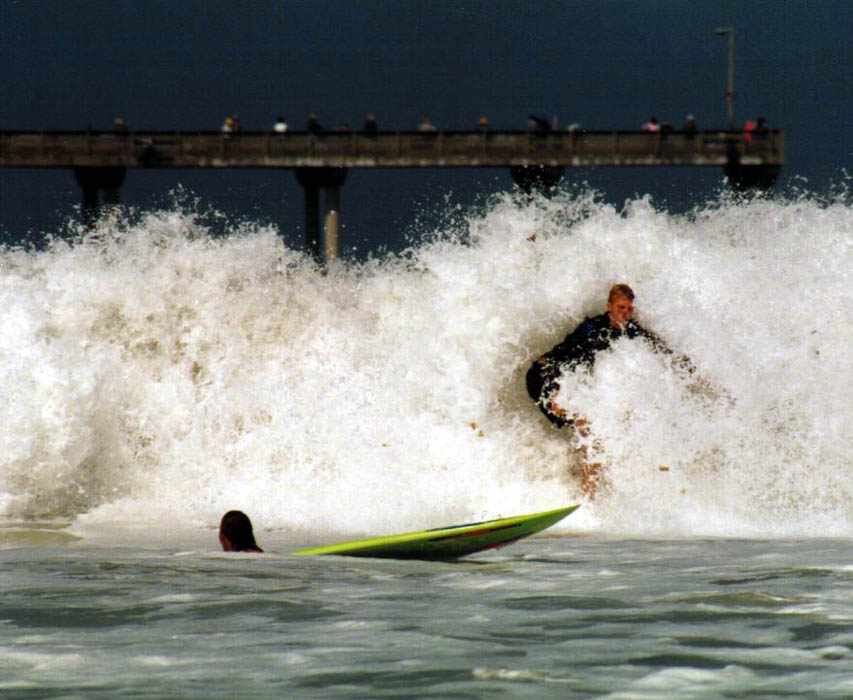 surfer about to be mown down by another surfer being engulfed in a wave